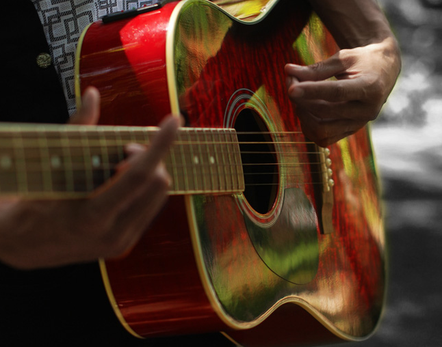 strumming a guitar